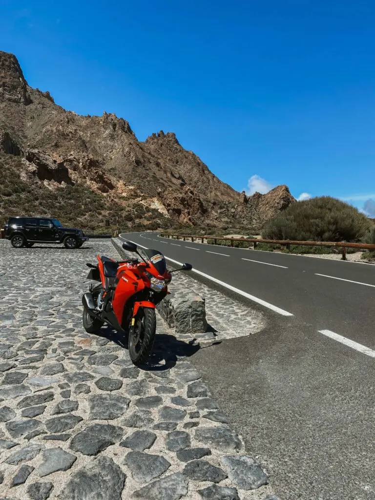 motorcycle parked near lava fields