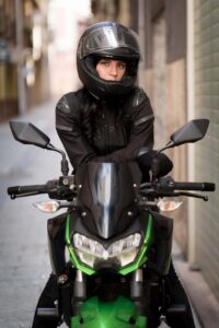 girl with helmet on front of kawasaki