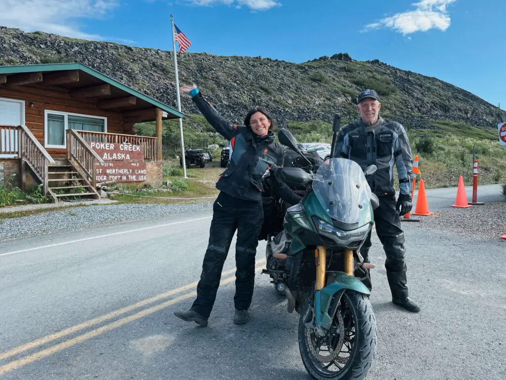 dad and daughter crossing alaska canada border by motorcycle